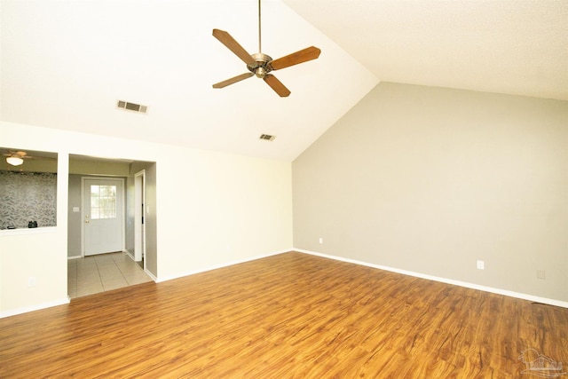 empty room featuring light wood-type flooring, lofted ceiling, and ceiling fan