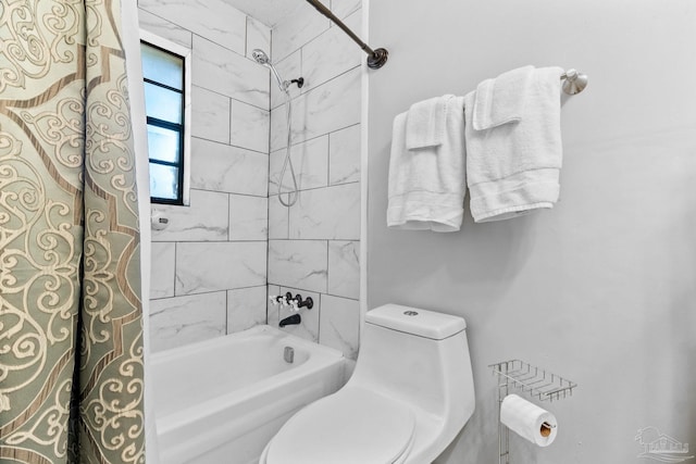 bathroom featuring shower / bathing tub combination and toilet