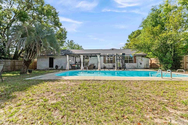 back of property featuring a fenced in pool, a fenced backyard, and a lawn