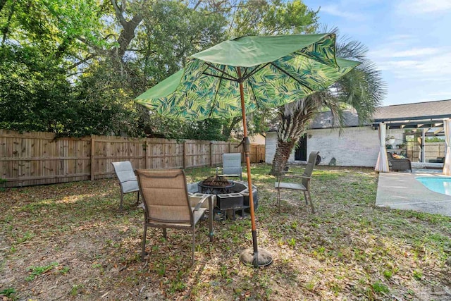 view of yard featuring a fire pit and fence