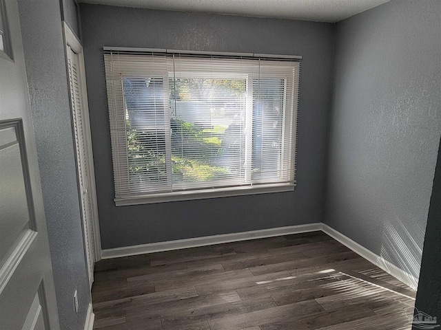 empty room with dark wood-type flooring