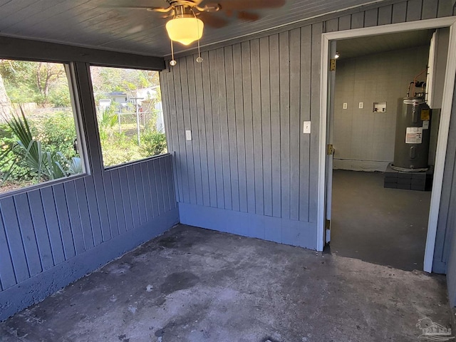 unfurnished sunroom featuring water heater