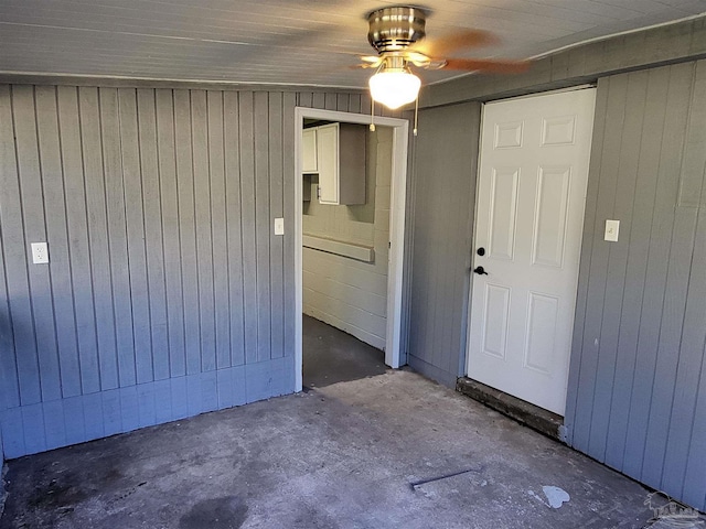 empty room featuring wood walls