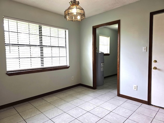 1900 W Kingsfield Rd, Cantonment, FL 32533 - unfurnished room with water heater, light tile patterned flooring, and a textured ceiling