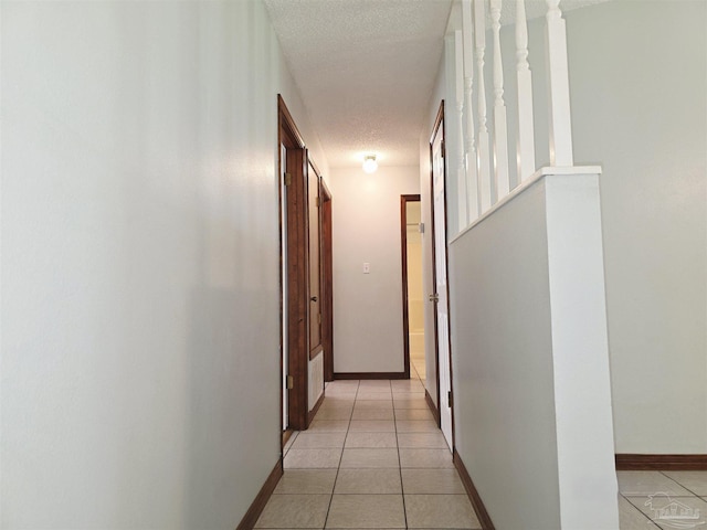 1900 W Kingsfield Rd, Cantonment, FL 32533 - corridor featuring a textured ceiling and light tile patterned floors