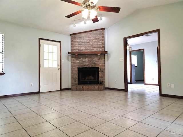 1900 W Kingsfield Rd, Cantonment, FL 32533 - unfurnished living room with lofted ceiling, a ceiling fan, a brick fireplace, and light tile patterned floors