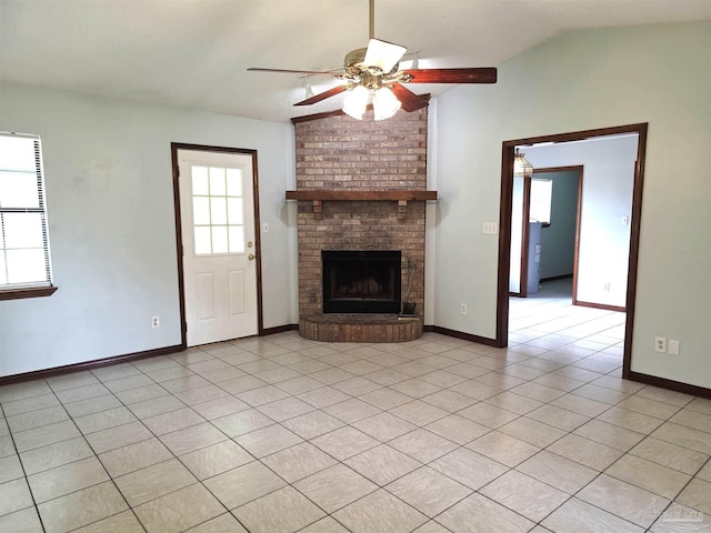 1900 W Kingsfield Rd, Cantonment, FL 32533 - unfurnished living room featuring a ceiling fan, a brick fireplace, vaulted ceiling, and light tile patterned floors