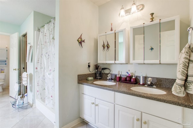 3017 Southsky Ln, Pensacola, FL 32506 - bathroom with toilet, double vanity, a shower stall, and baseboards