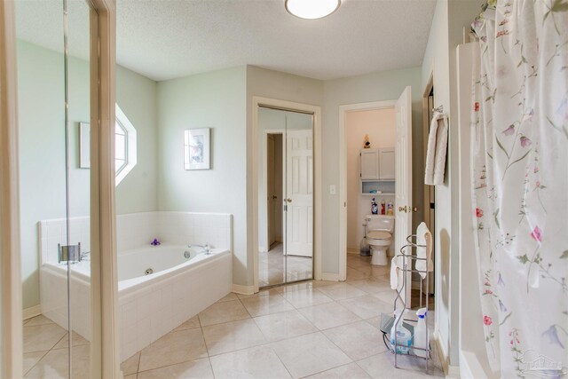 3017 Southsky Ln, Pensacola, FL 32506 - full bath featuring a garden tub, curtained shower, tile patterned flooring, toilet, and a textured ceiling