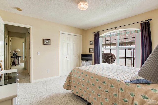 3017 Southsky Ln, Pensacola, FL 32506 - bedroom with a closet, carpet floors, a textured ceiling, and baseboards