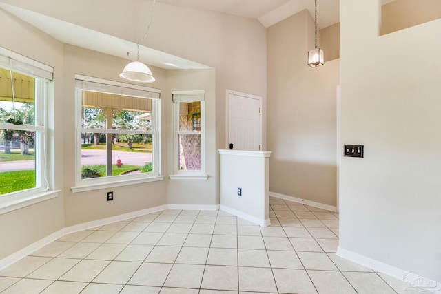 3881 Windsor Castle Blvd, Milton, FL 32583 - unfurnished dining area featuring healthy amount of natural light, high vaulted ceiling, baseboards, and light tile patterned floors
