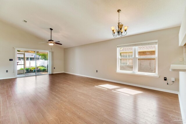 3881 Windsor Castle Blvd, Milton, FL 32583 - unfurnished living room featuring hardwood / wood-style flooring, a chandelier, a ceiling fan, baseboards, and vaulted ceiling