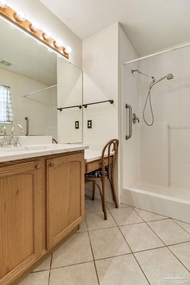 3881 Windsor Castle Blvd, Milton, FL 32583 - bathroom featuring tile patterned floors, a shower, vanity, and a textured ceiling