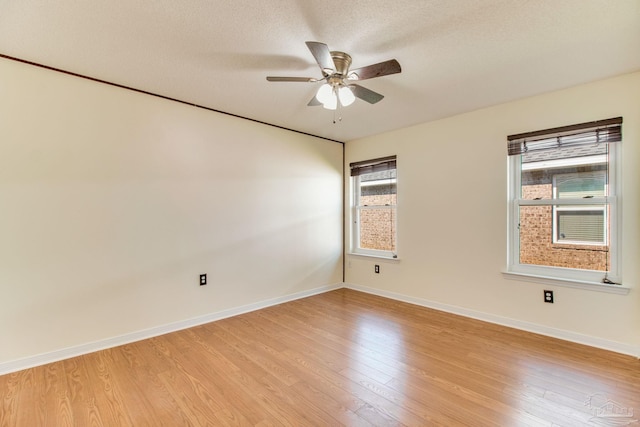3881 Windsor Castle Blvd, Milton, FL 32583 - spare room featuring healthy amount of natural light, light wood-type flooring, ceiling fan, baseboards, and a textured ceiling