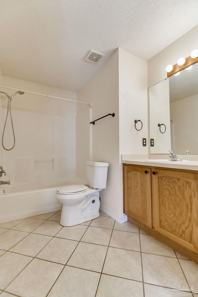 3881 Windsor Castle Blvd, Milton, FL 32583 - full bath featuring tile patterned flooring, toilet, a textured ceiling, vanity, and shower / bath combination