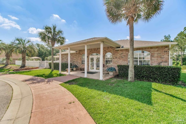 3881 Windsor Castle Blvd, Milton, FL 32583 - back of house with french doors and brick siding
