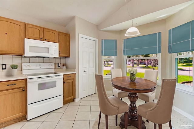 3881 Windsor Castle Blvd, Milton, FL 32583 - kitchen featuring white appliances, light countertops, light tile patterned floors, vaulted ceiling, and tasteful backsplash