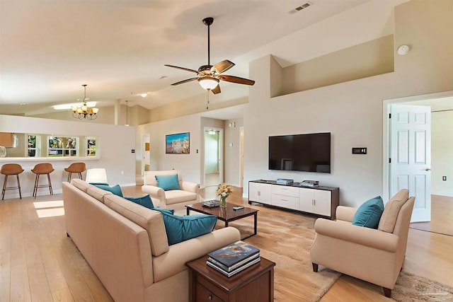 3881 Windsor Castle Blvd, Milton, FL 32583 - living room with light wood finished floors, a chandelier, a ceiling fan, and high vaulted ceiling