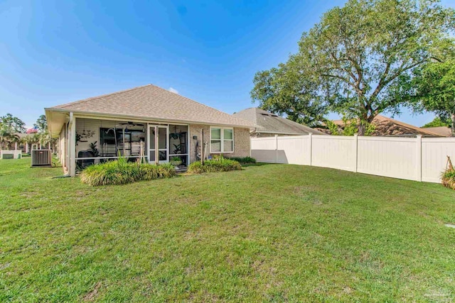 3881 Windsor Castle Blvd, Milton, FL 32583 - rear view of house featuring central AC unit, ceiling fan, a sunroom, and a shingled roof
