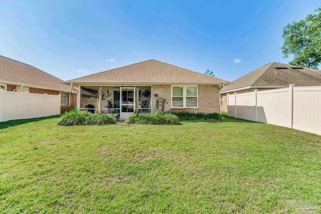 3881 Windsor Castle Blvd, Milton, FL 32583 - back of property with a sunroom and brick siding