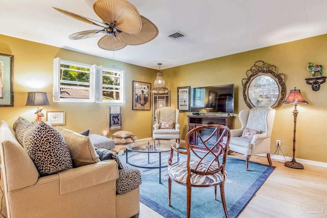 living room with hardwood / wood-style floors and ceiling fan