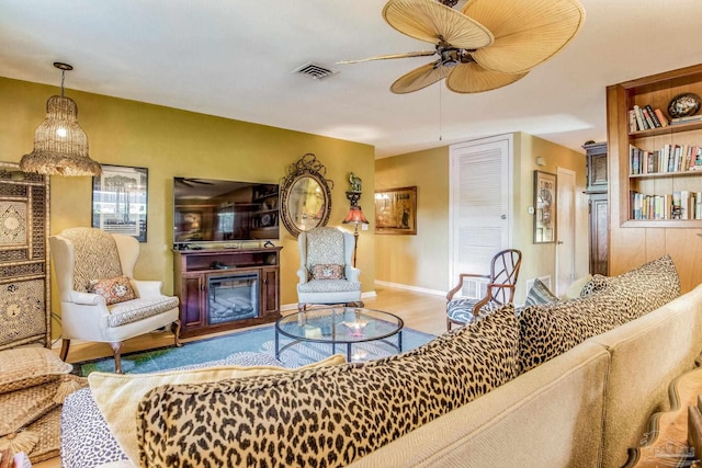 living room with ceiling fan and light hardwood / wood-style floors