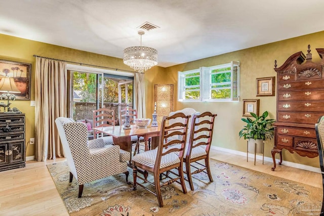 dining room featuring a chandelier and light hardwood / wood-style floors