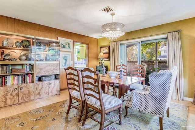 dining room featuring an inviting chandelier and light hardwood / wood-style flooring