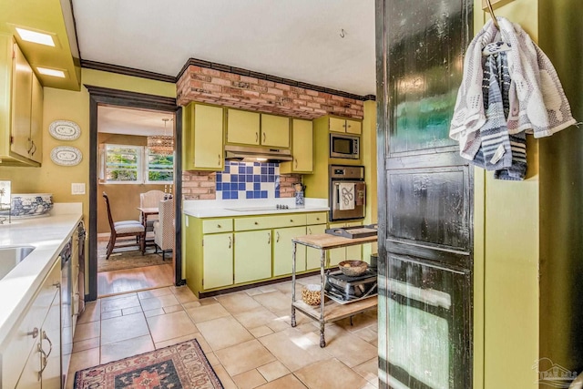 kitchen with decorative backsplash, light tile patterned flooring, stainless steel appliances, and ornamental molding