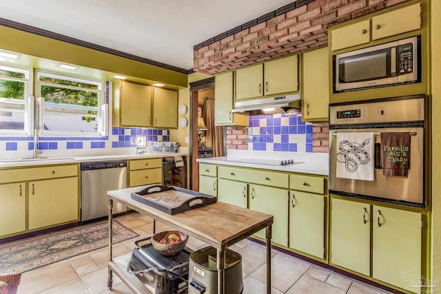 kitchen featuring light tile patterned floors, sink, appliances with stainless steel finishes, and tasteful backsplash