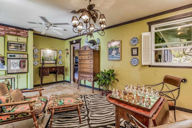 living area with ceiling fan with notable chandelier, light tile patterned floors, and crown molding