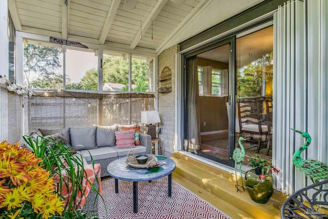 sunroom / solarium with vaulted ceiling with beams and wooden ceiling