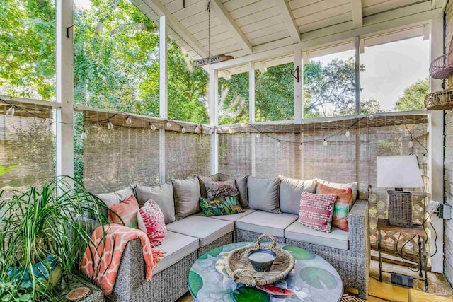 sunroom with lofted ceiling with beams and wood ceiling