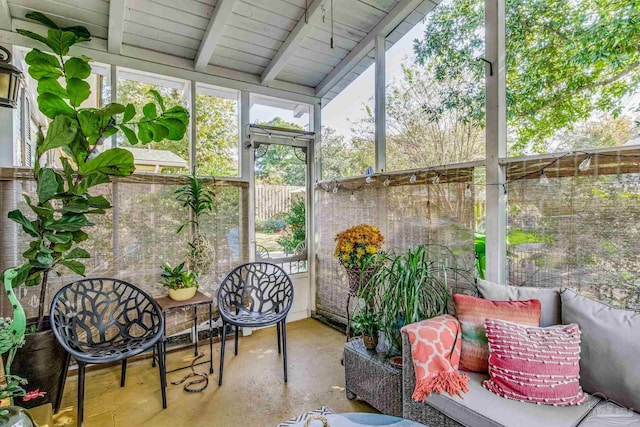 sunroom / solarium with vaulted ceiling with beams