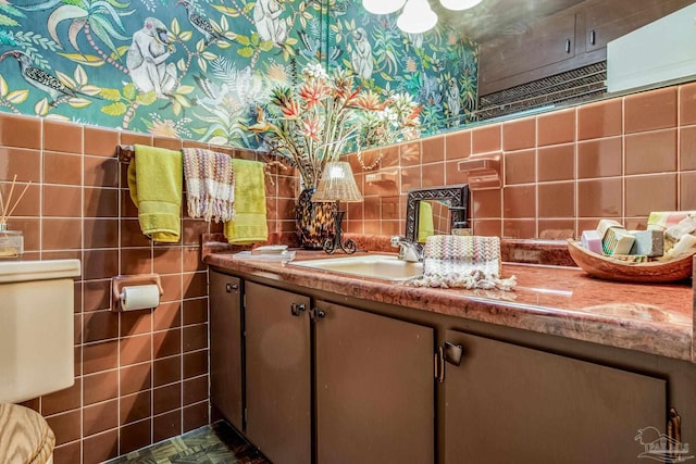 bathroom featuring vanity and tile walls