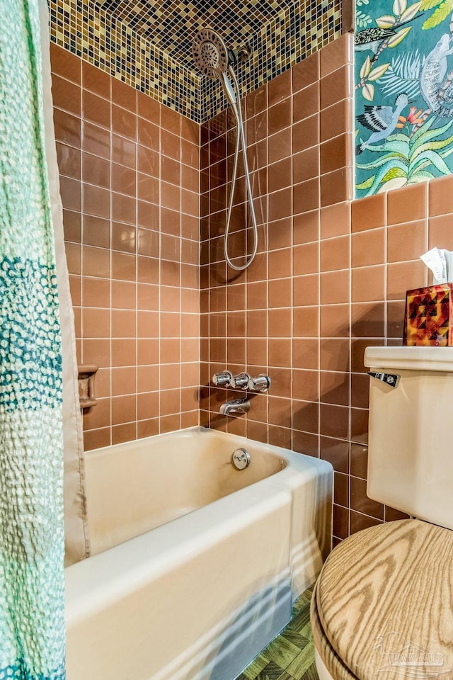 bathroom with shower / bathtub combination with curtain, toilet, and tile walls