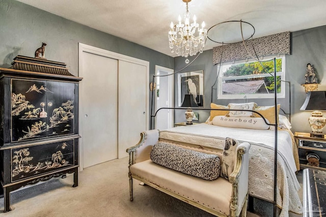 carpeted bedroom featuring a closet and a chandelier