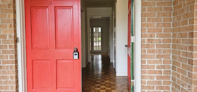 doorway to property featuring brick siding