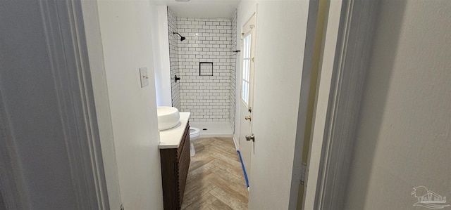 bathroom featuring toilet, a shower stall, and vanity