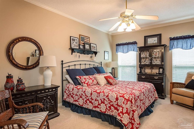 carpeted bedroom with ceiling fan, ornamental molding, and a textured ceiling