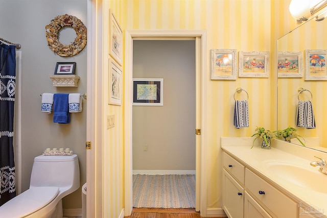 bathroom featuring vanity and toilet