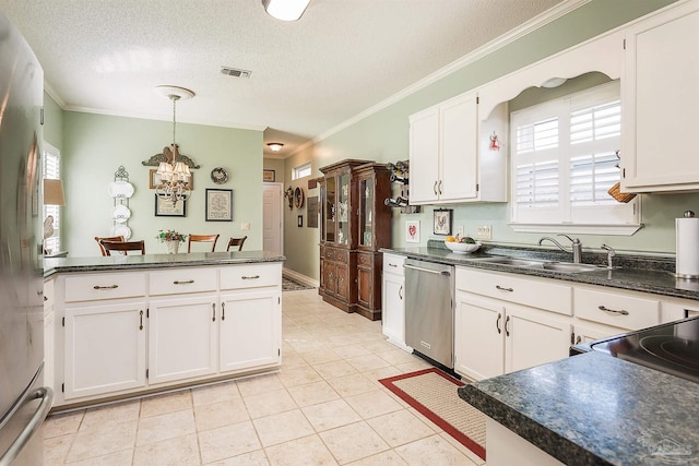 kitchen featuring white cabinetry, appliances with stainless steel finishes, sink, and pendant lighting