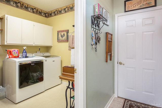 washroom with separate washer and dryer and cabinets