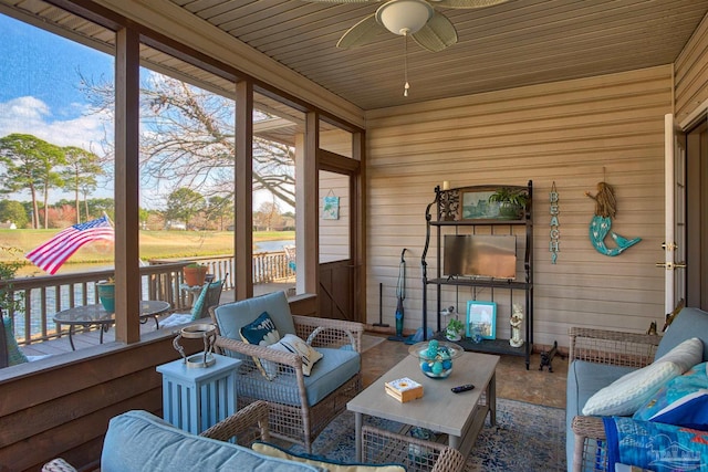 sunroom featuring ceiling fan