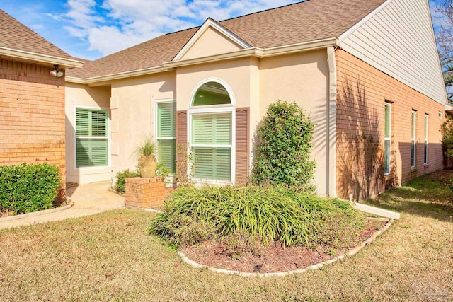 doorway to property featuring a yard