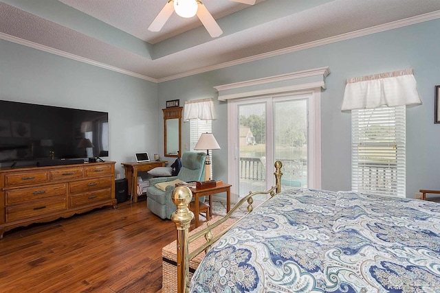 bedroom featuring crown molding, hardwood / wood-style flooring, ceiling fan, a tray ceiling, and access to outside