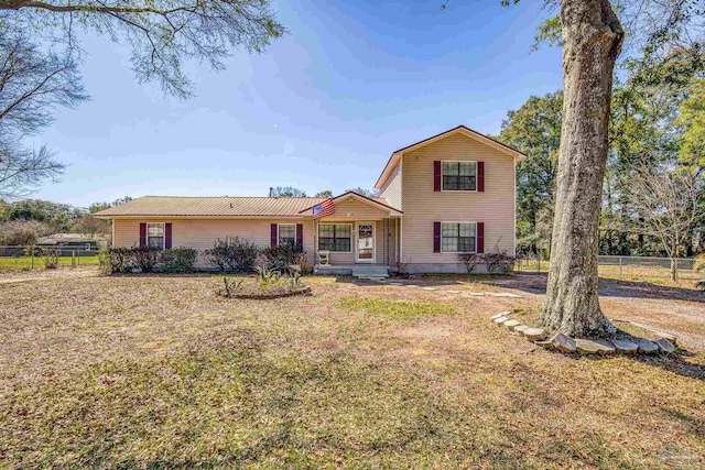 view of front of property with a front yard and fence