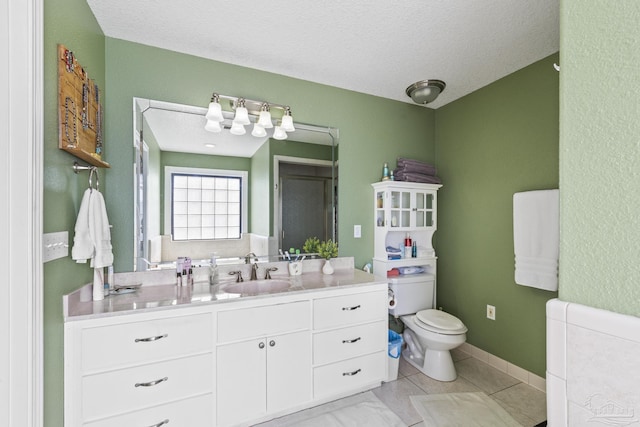 full bath with toilet, baseboards, a textured ceiling, and vanity