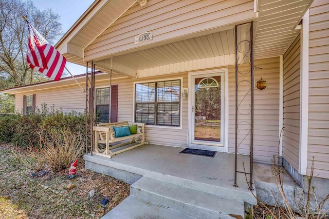 entrance to property featuring a porch