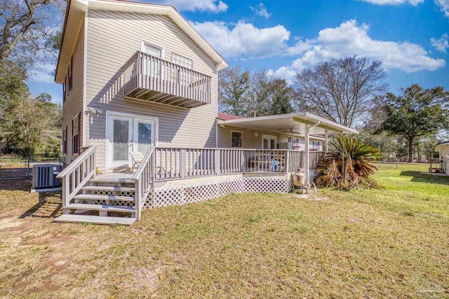 exterior space featuring a wooden deck, a lawn, a balcony, french doors, and central air condition unit